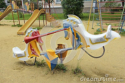 Children swing in the form of horses. Playground. Stock Photo