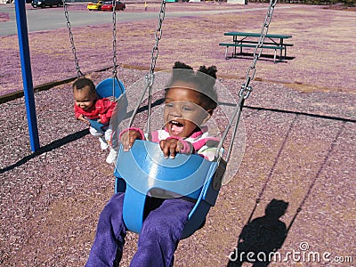 Children on Swings Stock Photo