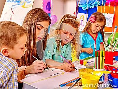 Children with teacher woman painting on paper in Stock Photo