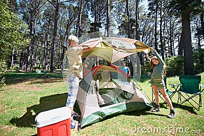 Children, tent and team camping in forest for shelter, cover or insurance together on the grass in nature. Happy kids in Stock Photo