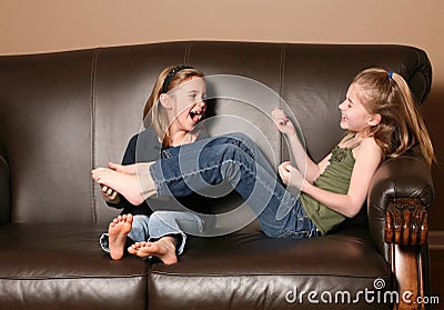 Children tickling feet Stock Photo