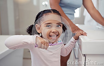 Children, toothbrush and toothpaste with a girl brushing teeth in the bathroom at home for dental hygiene or care Stock Photo