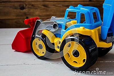 Children toys tractor on wooden background Stock Photo