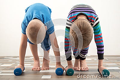 Children train with dumbbells. The concept of sport in the family Stock Photo
