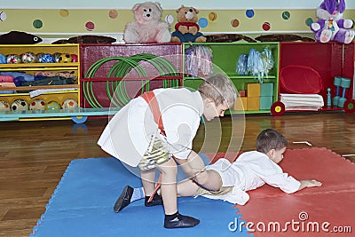 Children train grasps in judogi Stock Photo