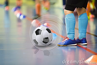 Children training soccer futsal indoor gym. Young boy with soccer ball training indoor football. Little player in light blue sport Stock Photo