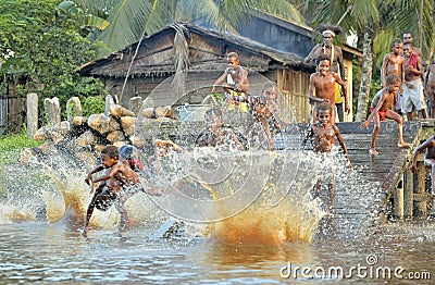 Children of the tribe of Asmat people bathe and swim in the river Editorial Stock Photo