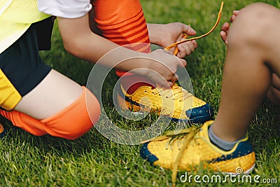 Children tying shoe laces. Kids on sports football team tying soccer cleats Stock Photo