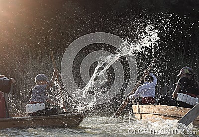 Children under the spray of water in the floating boats Editorial Stock Photo