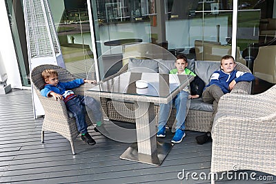 Children waiting food in outdoor cafe Stock Photo