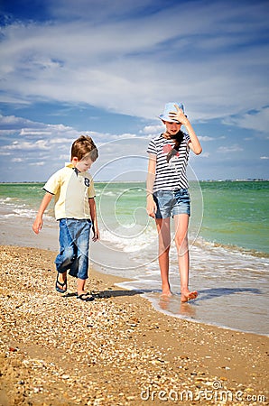 Children walk along the coast vertical Stock Photo