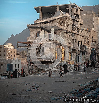 Children walk on the rubble of destroyed homes in Yemen Editorial Stock Photo