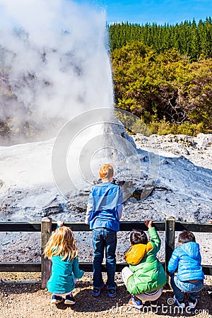 ROTORUA, NEW ZEALAND - OCTOBER 10, 2018: Children watch the eruption of Lady Knox geyser in Wai-O-Tapu. Vertical Editorial Stock Photo