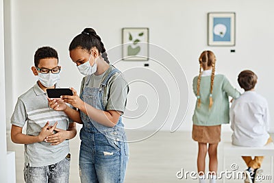 Children Wearing Masks in Art Gallery Stock Photo