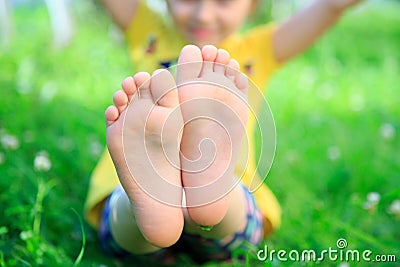 Children& x27;s feet on grass. picnic in park Stock Photo