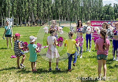 Children and young women â€“ volunteers, participating at cheerleading training Editorial Stock Photo