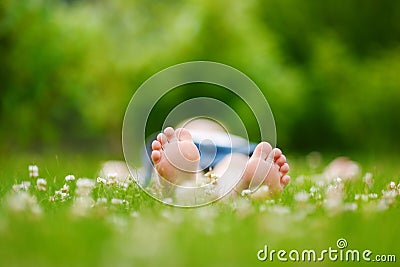 Childrens feet on grass outdoors Stock Photo