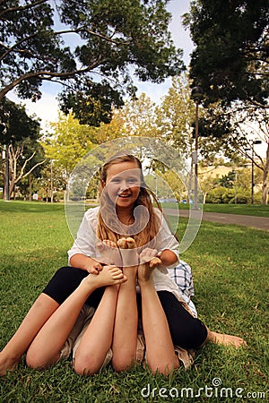 Childrens feet tickling Stock Photo