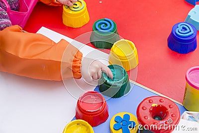 Childrens hand, green paint, childrens creativity Stock Photo