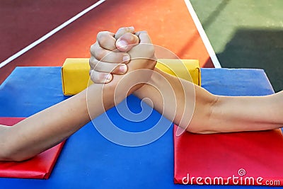 Childrens hands, arm wrestling Stock Photo