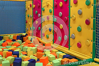 Childrens playroom. Childrens climbing wall with colorful figures. Soft room for games Stock Photo