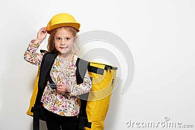 Childrens profession. Little child girl trying on a yellow suit delivery man, courier. Online shopping Stock Photo
