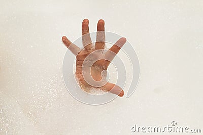 Childs hand in fshampoo foam in bath. Healthcare and hygiene con Stock Photo