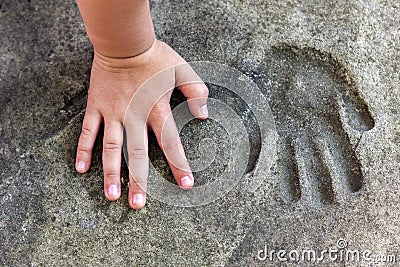 Childs hand and memorable handprint in concrete Stock Photo