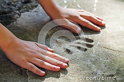 Childs hand and memorable handprint in concrete Stock Photo