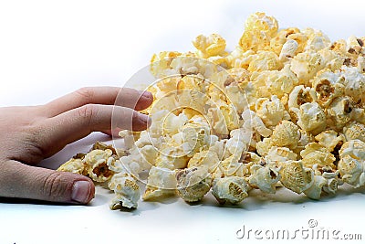 A Childs hand reaching for some popcorn Stock Photo