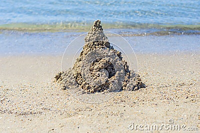 A Childs sand castle waiting for the ocean tide to come in to reclaim it Stock Photo