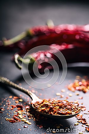 Chili. Chili peppers. Several dried chilli peppers and crushed peppers on an old spoon spilled around. Mexican ingredients Stock Photo