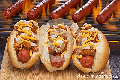 Chili Hot Dogs Grilled in Buns and on Barbecue Grill Stock Photo