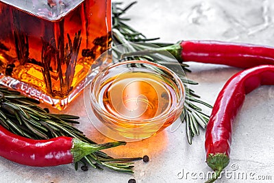 Chili oil with ingredients on kitchen table background Stock Photo