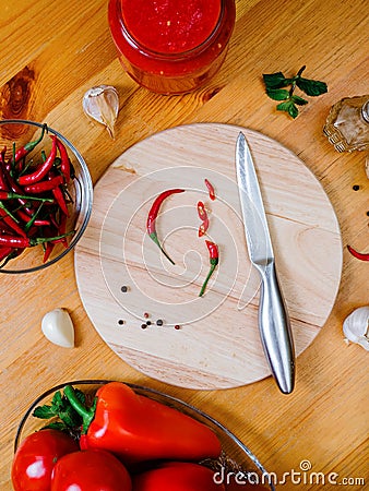 chili sauce preparation: small hot peppers on a round cutting board Stock Photo