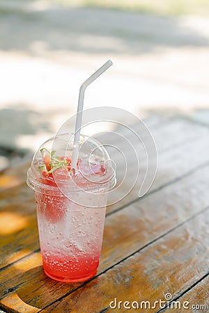 Chill out with strawberry soda cocktail on wood table at the Cafe for fresh summer or relax time after hard working. Stock Photo