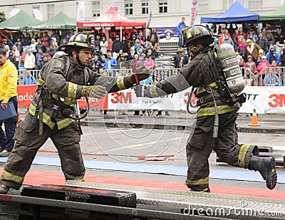 Professional firefighters completing the circuit during the competition. Editorial Stock Photo