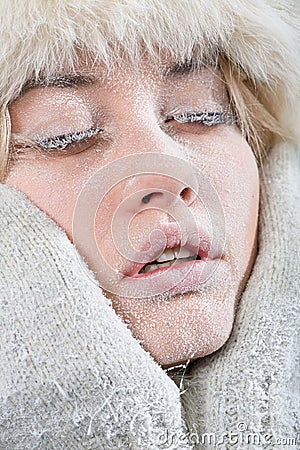 Chilled female face covered in ice. Stock Photo