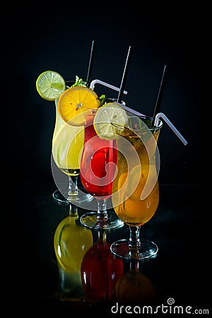 chilled fruity cocktails on a black mirrored background with slices fruits Stock Photo