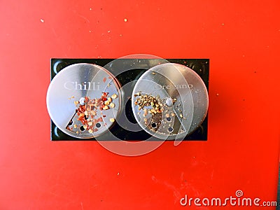 Chilli flakes and oregano spices stored in small cans Stock Photo
