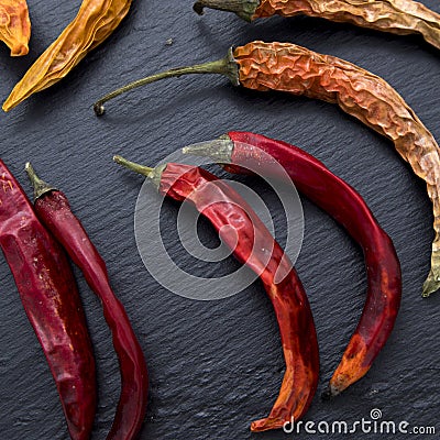 Chilli pepper - sun-dried is on black stone background Stock Photo