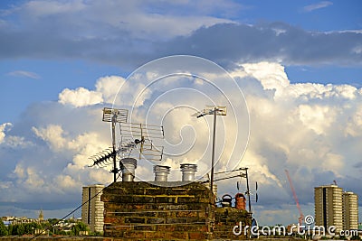 Chimney and antennae under beautiful sky Stock Photo