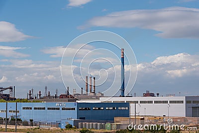 A chimney of ArcelorMittal formerly Ilva steel industry above the Tamburi Editorial Stock Photo