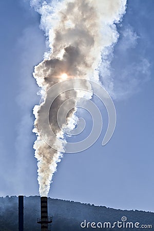 Chimney expelling pollutant gases to the air Stock Photo