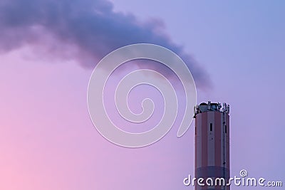 Chimney of an incineration plant, dawn windy morning Stock Photo