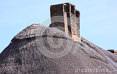 Chimney stack on thatch roof Stock Photo