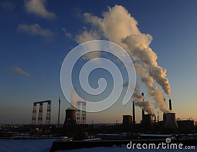 The chimney of a thermal power plant, the smoke extracted by a thermal power plant on the chimney, in the production process. Envi Stock Photo