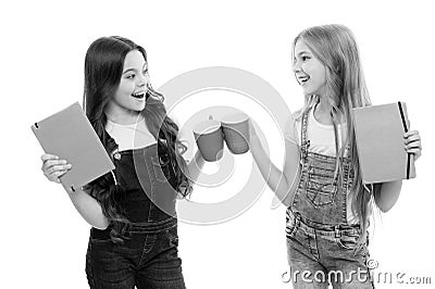 Chin chin. Little girls having tea break. Small children chinking cups together at meal break. Cute schoolgirls enjoying Stock Photo