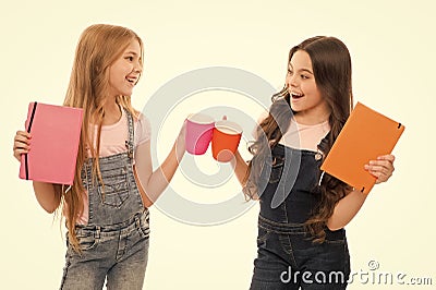 Chin chin. Little girls having tea break. Small children chinking cups together at meal break. Cute schoolgirls enjoying Stock Photo