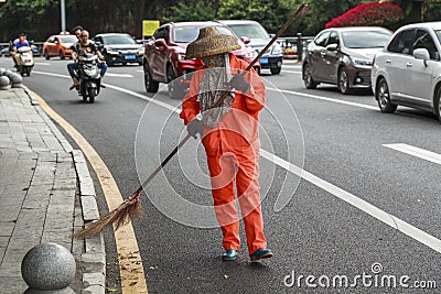 City street cleaners in special clothes with panicles and straw hats Editorial Stock Photo